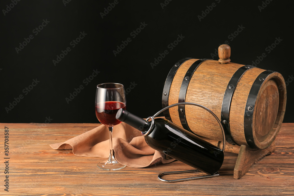 Holder with bottle and glass of wine on table