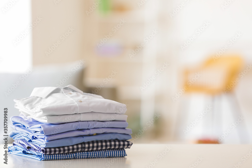 Stack of clean clothes on table in room