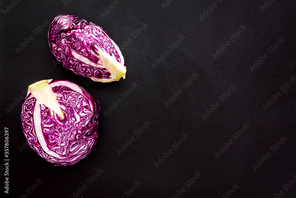 Red cabbage on black table top down copy space