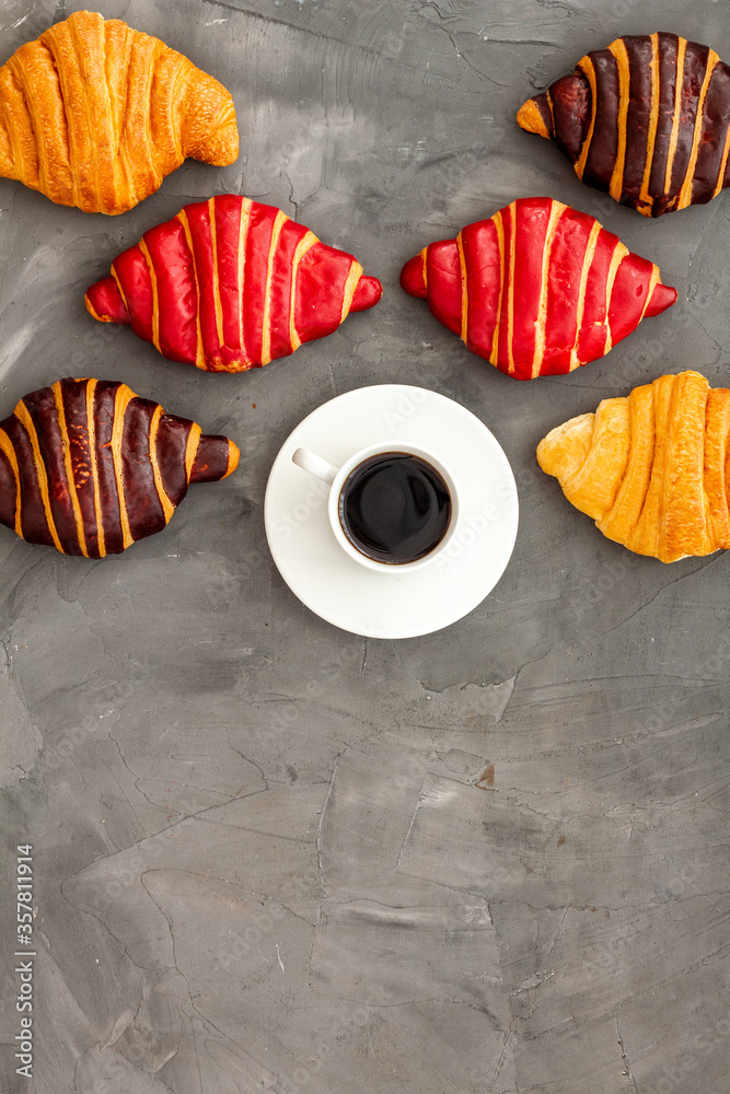 Set of coffee with croissants - chocolate, berry, classic - on stone table