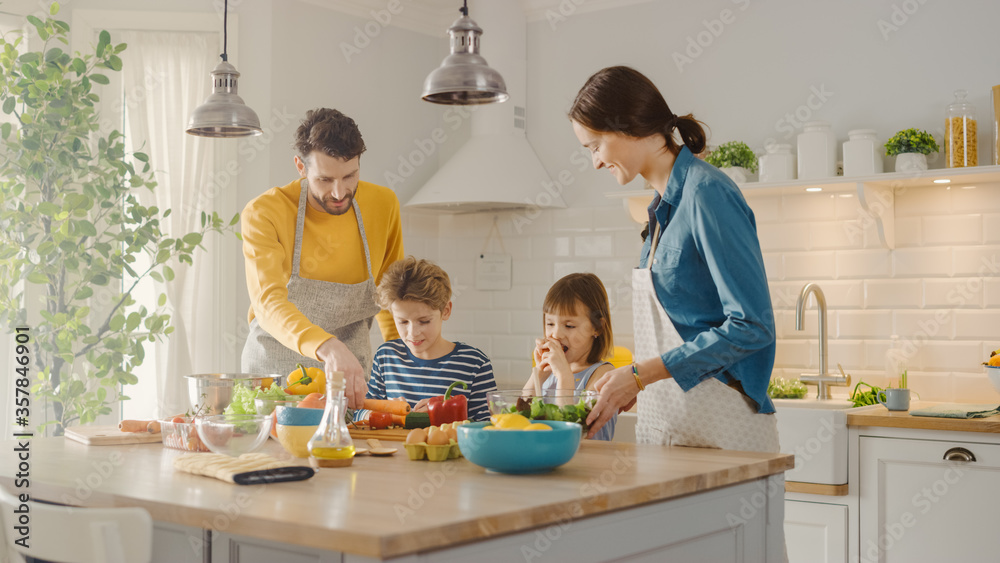 In Kitchen: Family of Four Cooking Together Healthy Dinner. Mother, Father, Little Boy and Girl, Pre