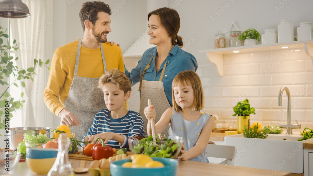 In Kitchen: Family of Four Cooking Together Healthy Dinner. Mother, Father, Little Boy and Girl, Pre