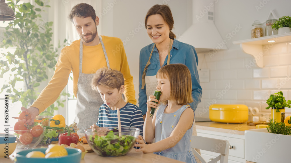 In Kitchen: Family of Four Cooking Together Healthy Dinner. Mother, Father, Little Boy and Girl, Pre