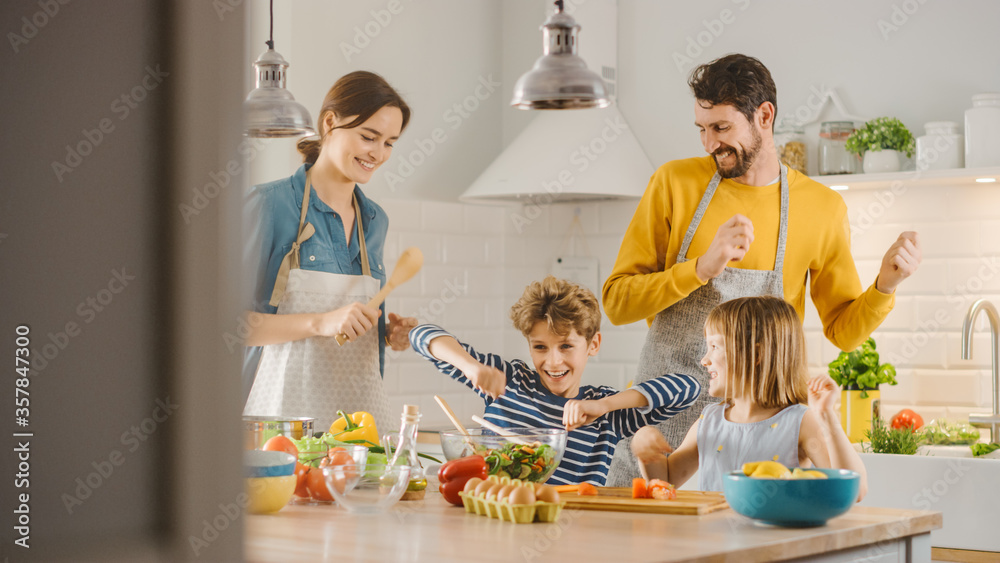 In Kitchen: Family of Four Cooking Together Healthy Dinner, Fool Around and Dance. Mother, Father, L