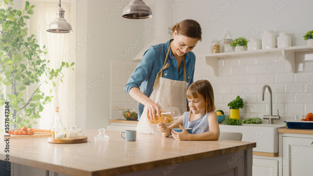 Breakfast in the Kitchen: Young Beautiful Mother Pours Cereal into Bowl, Adorable Little Daughter St