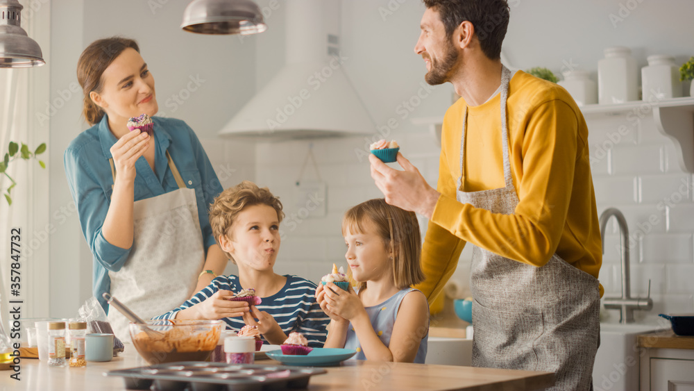 Gathered in the Kitchen: Adorable Family of Four Eating Creamy Cupcakes with Frosting and Sprinkled 