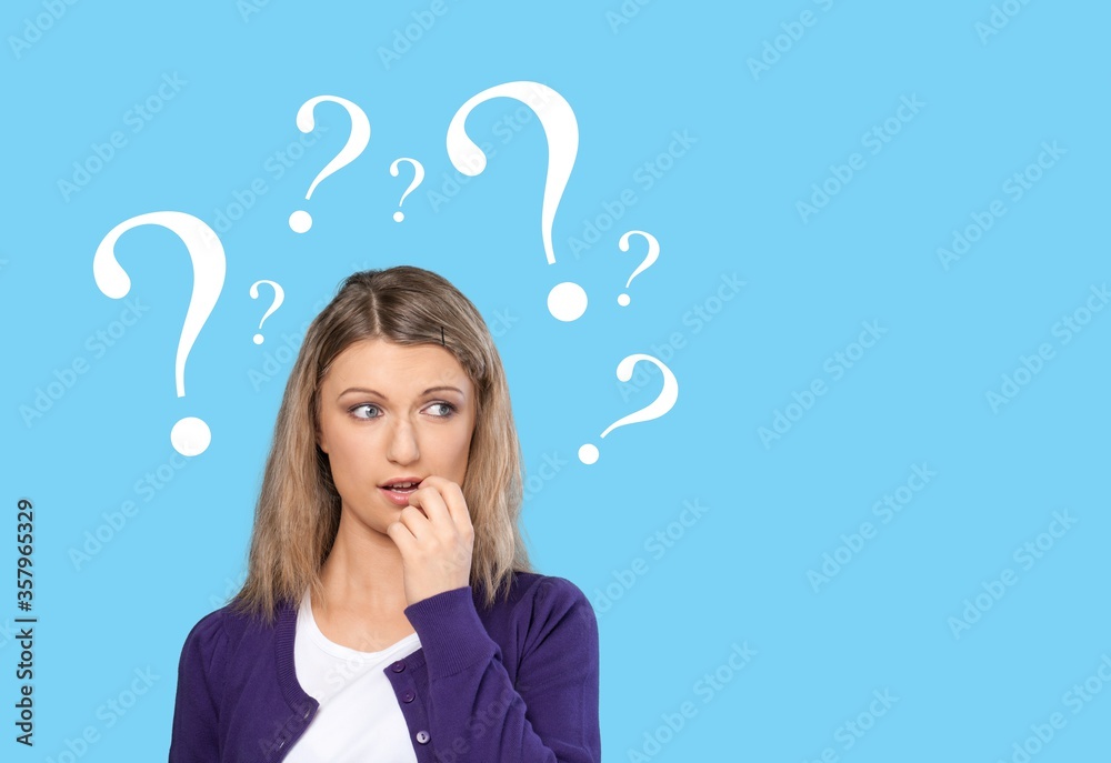 Question sign with a beautiful alarmed woman on pastel background