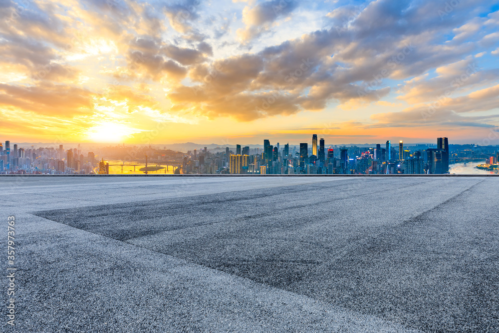 Empty racing track road and chongqing skyline with buildings at sunset.