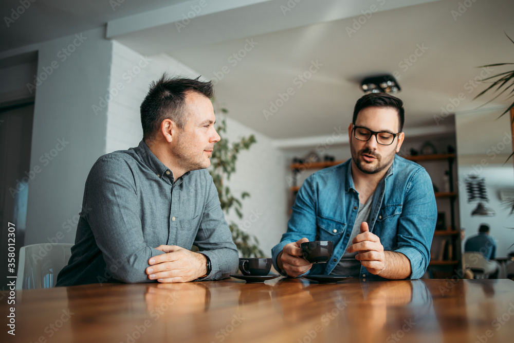 Two casual businessmen on a coffee break, portrait.