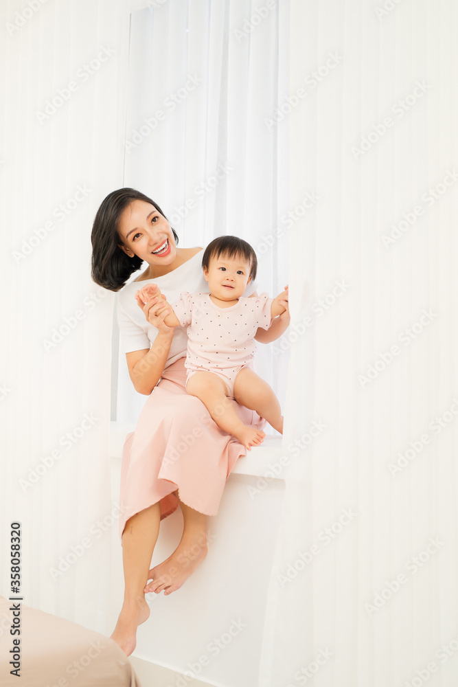 Happy mother day! Mom and her daughter child girl are playing, smiling and hugging