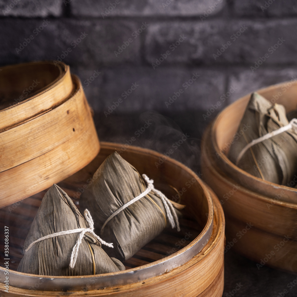 Rice dumpling, zongzi - Chinese rice dumpling zongzi on black brick background slate table, concept 