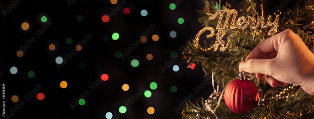 Christmas background concept- beautiful decor bauble hanging on the Christmas tree with sparkling li