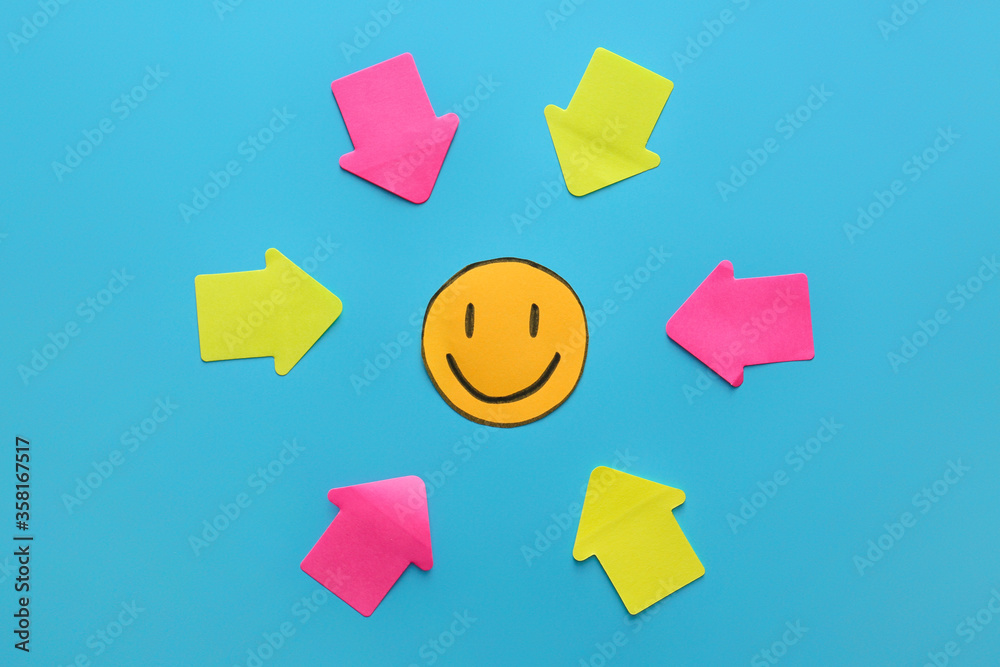 Paper smile with arrows on color background