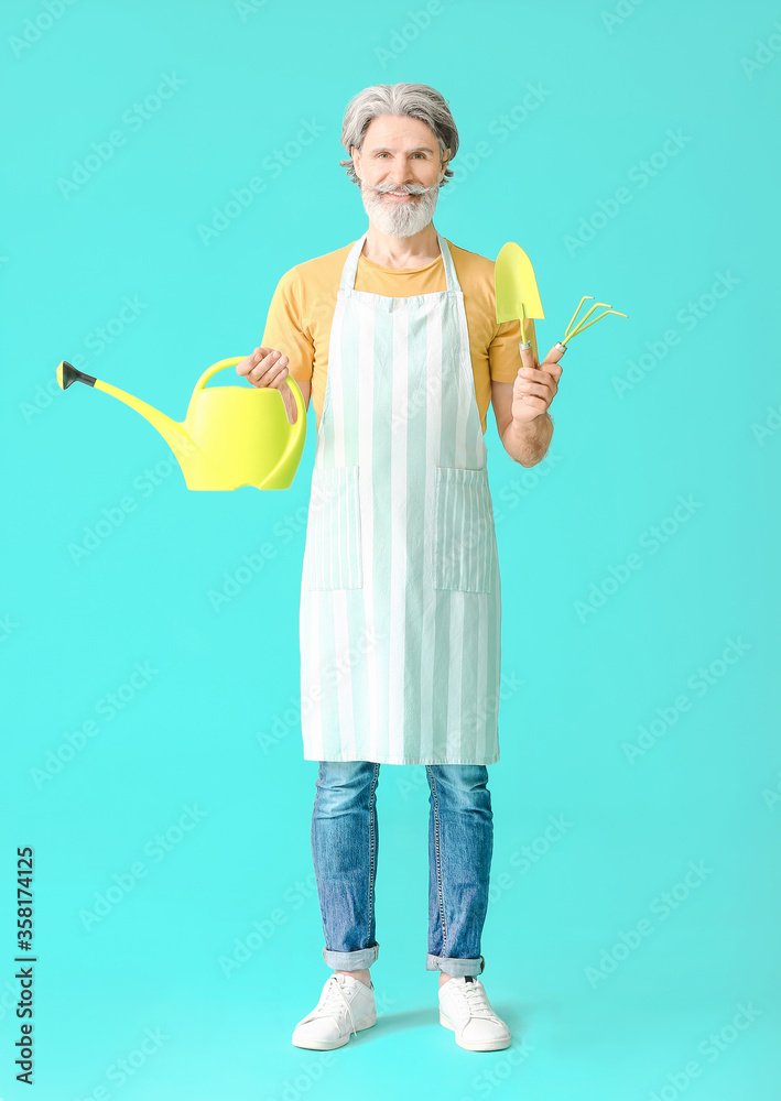 Senior gardener on color background