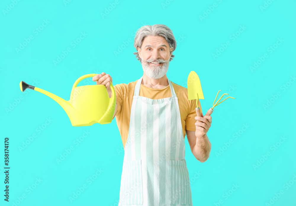 Senior gardener on color background