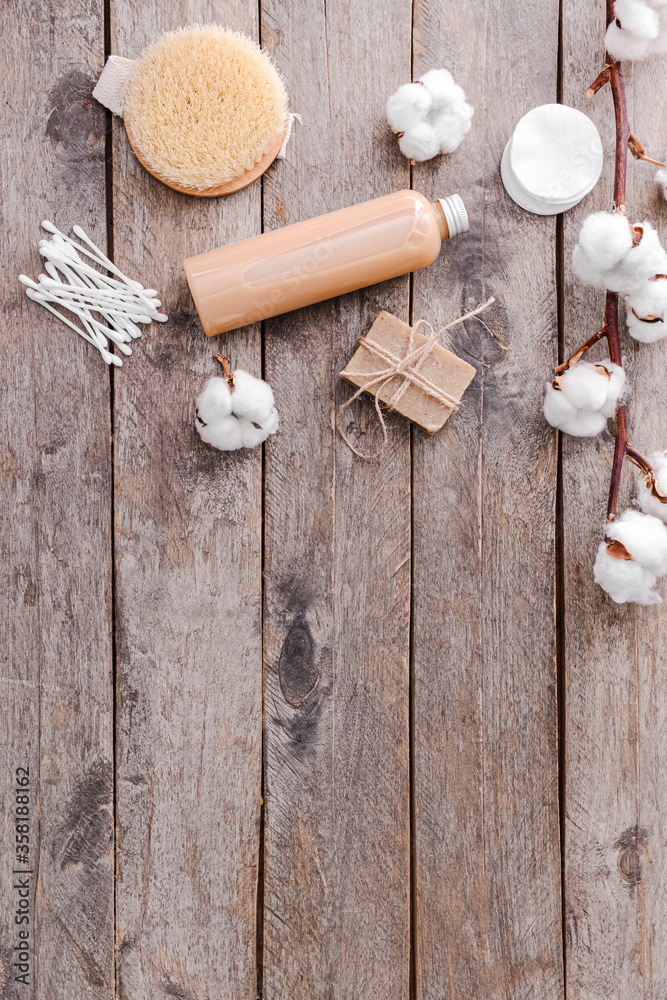 Cotton flowers with cosmetics and supplies on table