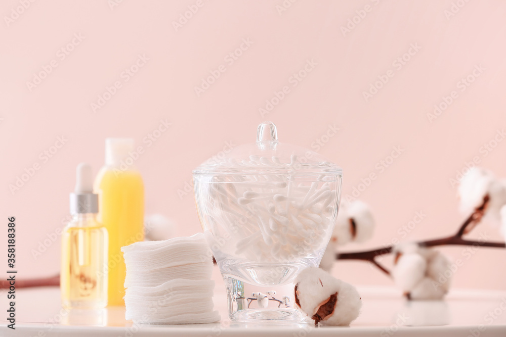 Cotton cosmetic pads and swabs on table