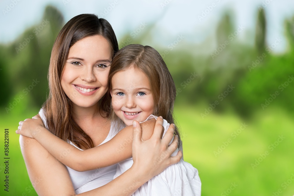 Happy beautiful mother and daughter hugging