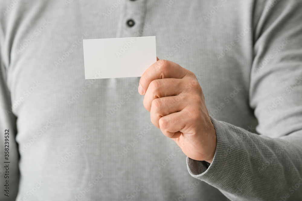 Man with blank business card, closeup