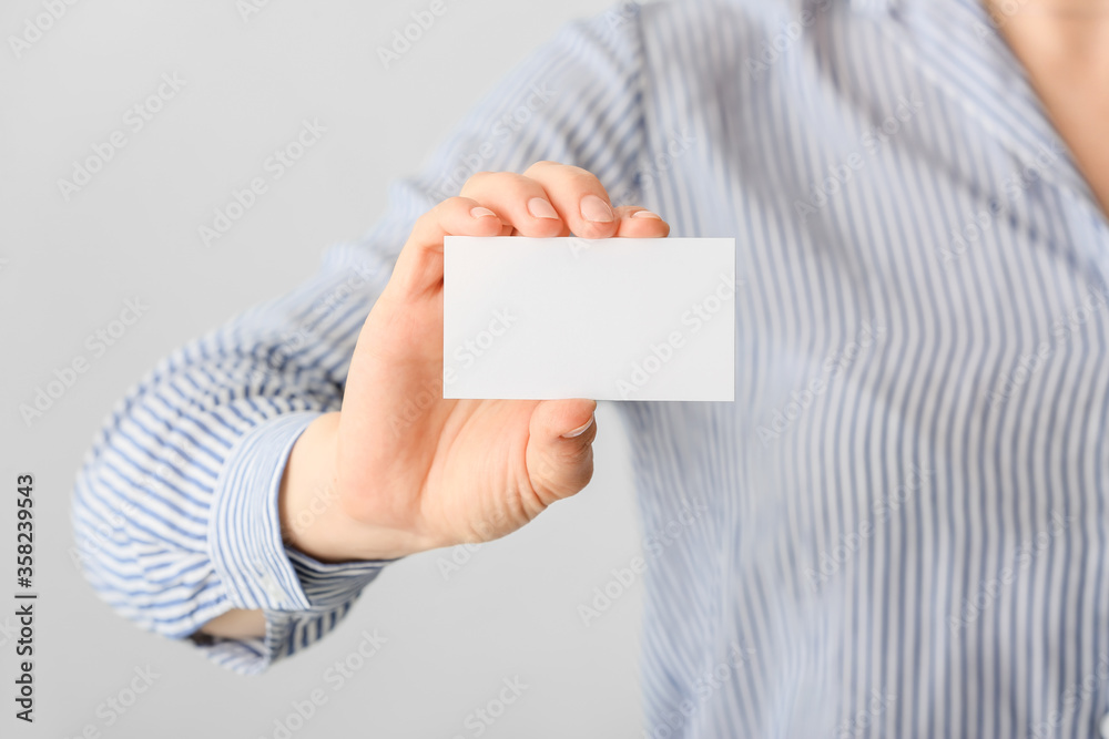 Woman with blank business card, closeup