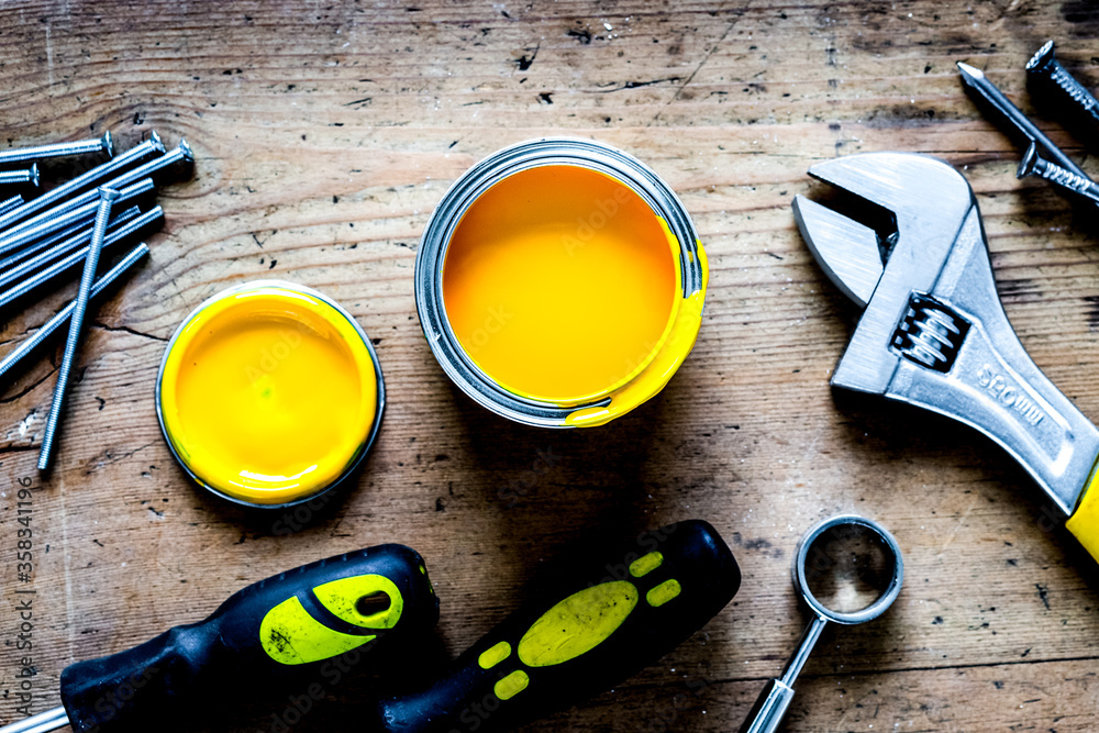 builder work with professional repairing implements set on wooden background top view