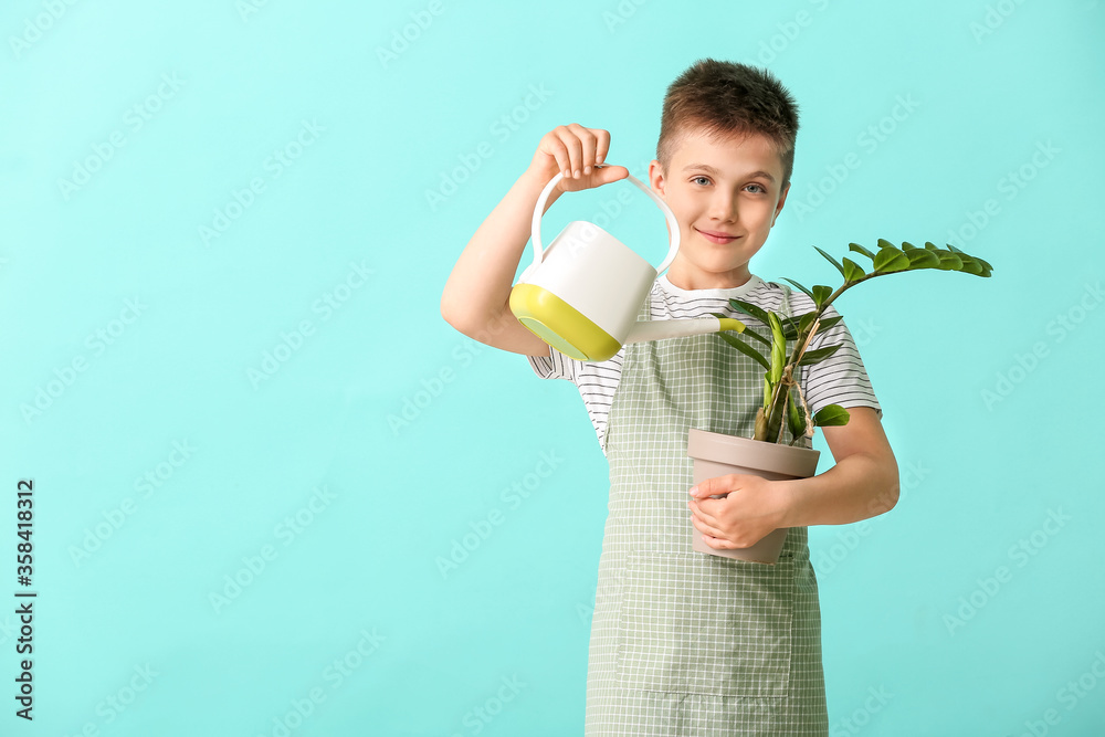 Cute little gardener on color background