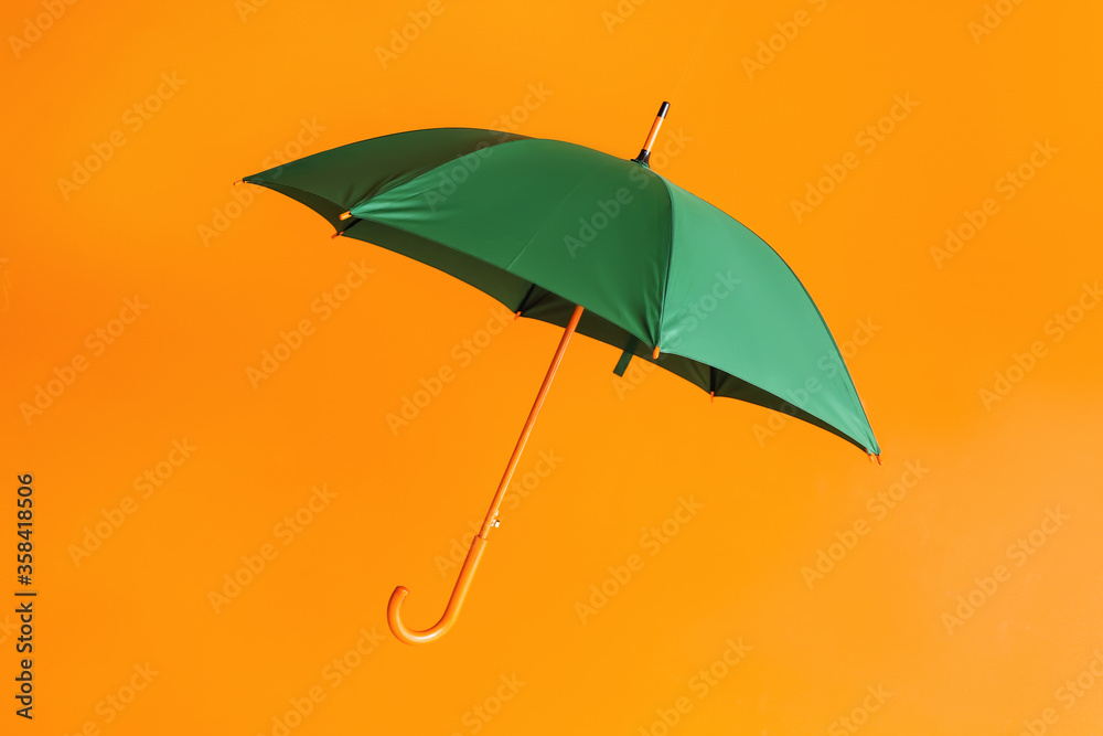 Stylish umbrella on color background