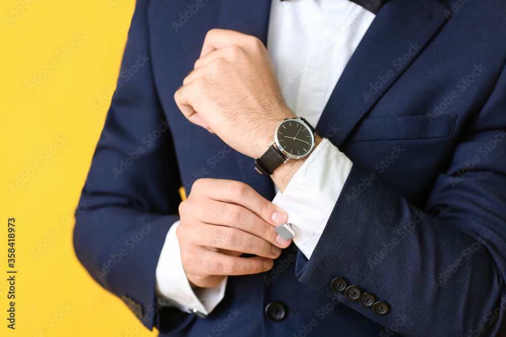 Young man in stylish suit on color background, closeup