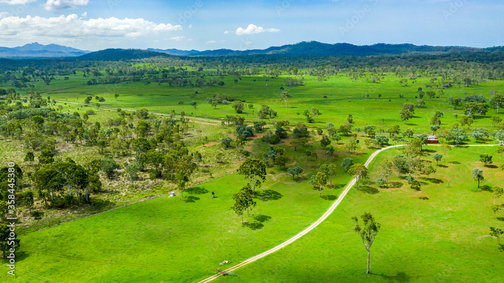 Vibrant green summer landscape showing a golf course and hills in the distance, in Calliope, Queensl