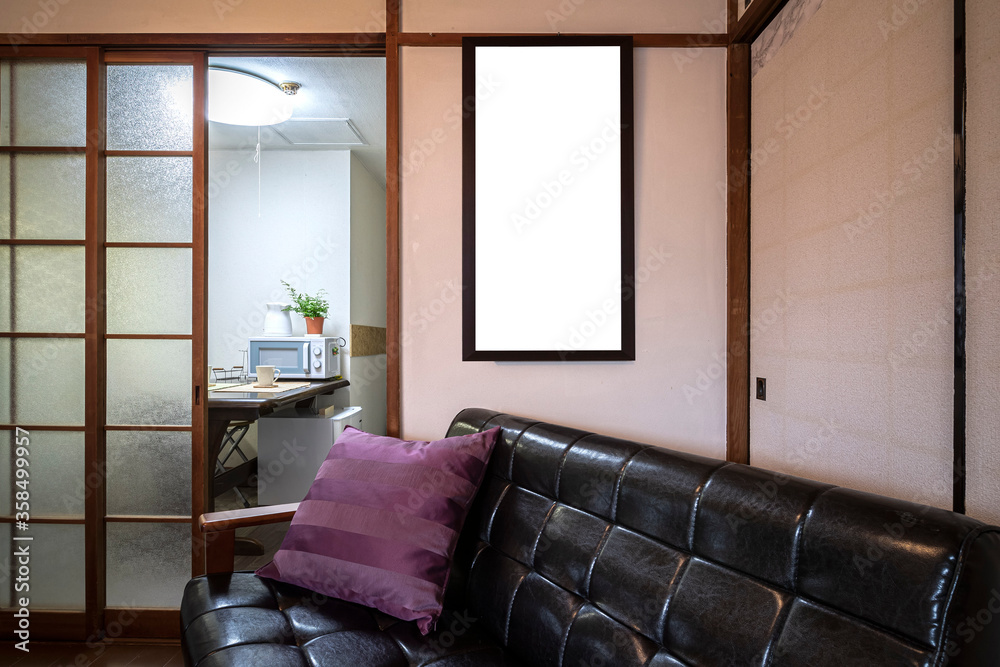 A blank picture frame on the wall in the living room of an old Japanese house