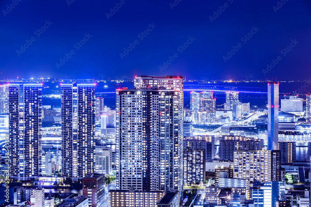 光が眩しい、東京の水辺に立ち並ぶ高層ビル群の夜景