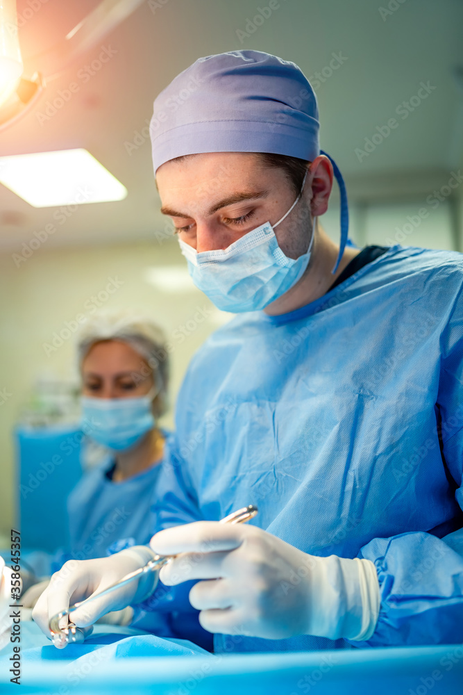 Portrait of a doctor or medical specialist. Vertical portrait. Man in scrubs. Light background with 