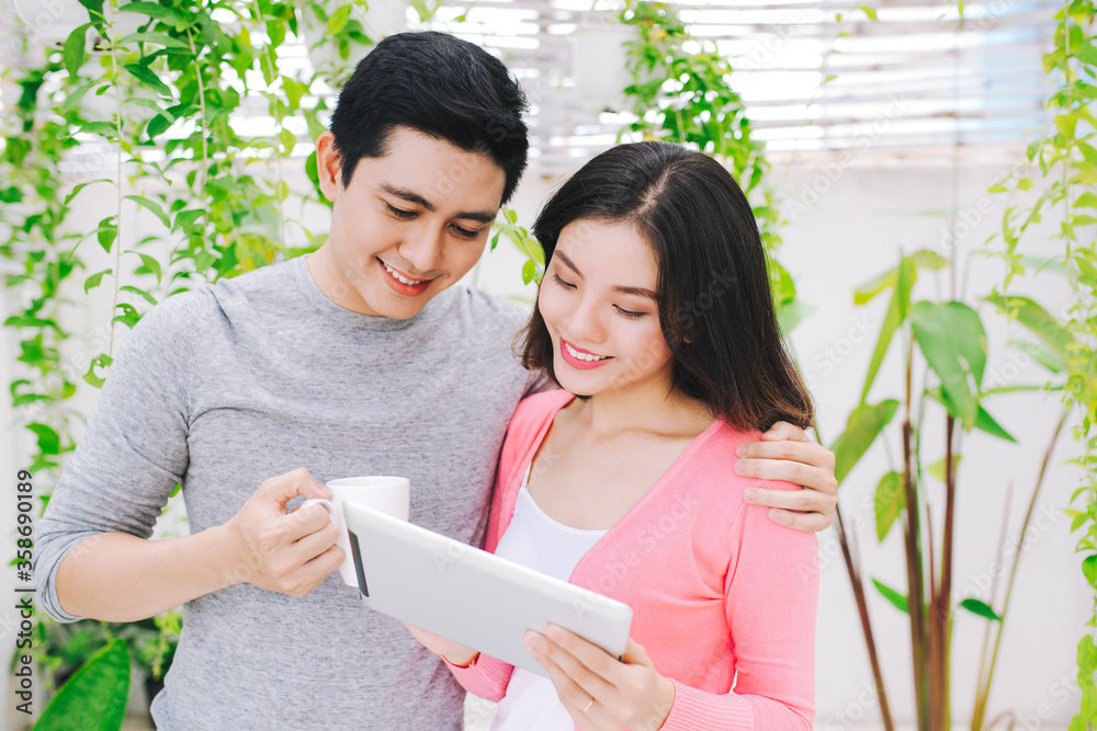 Young couple using tablet at the garden.