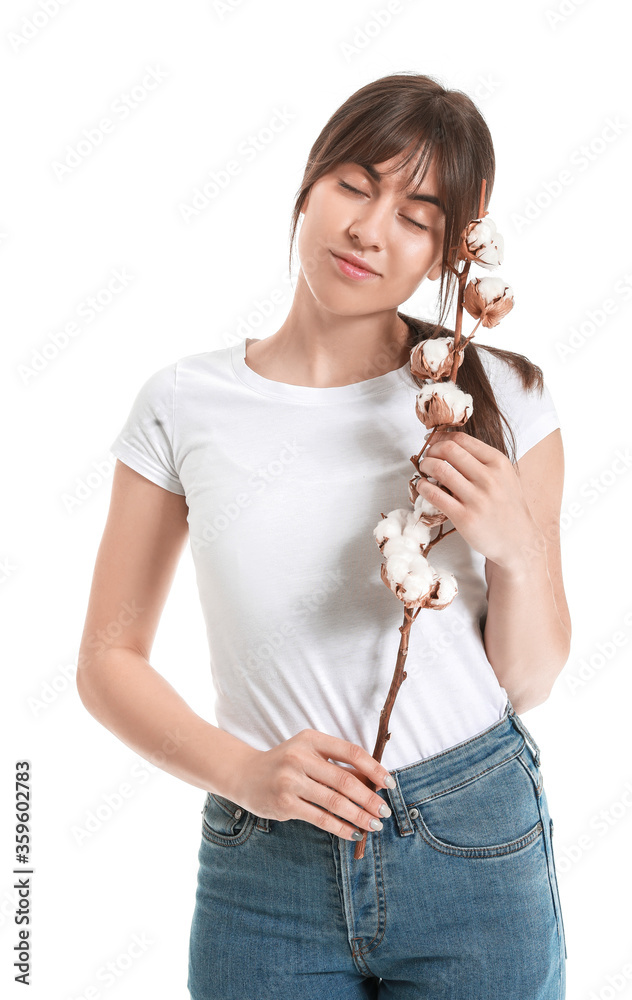 Beautiful young woman with cotton flowers on white background