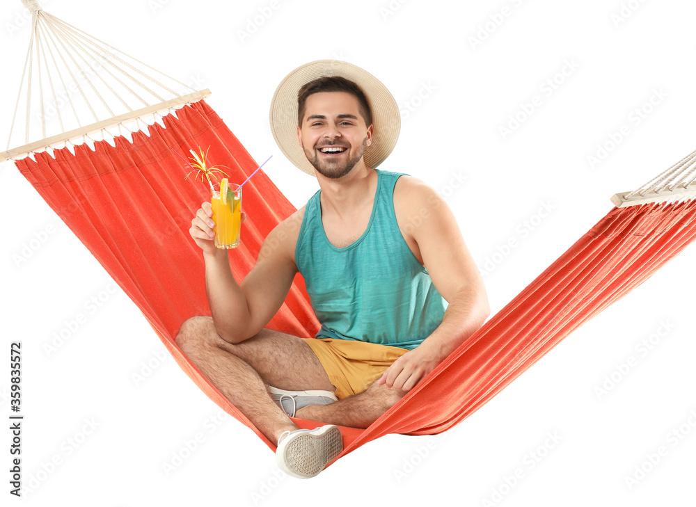 Young man with cocktail relaxing in hammock against white background