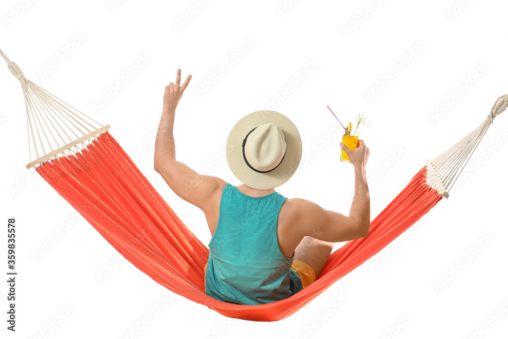 Young man with cocktail relaxing in hammock against white background