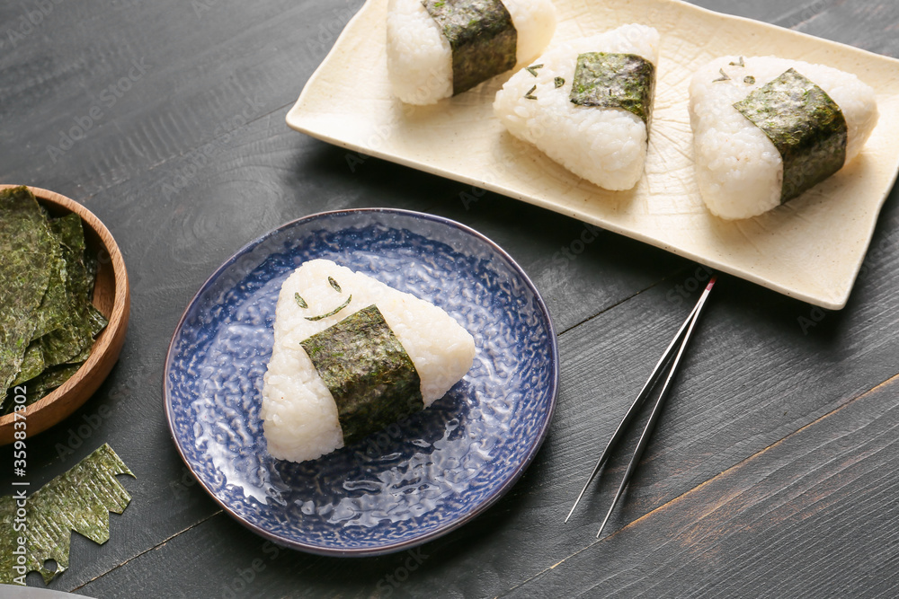 Traditional Japanese onigiri with nori on table