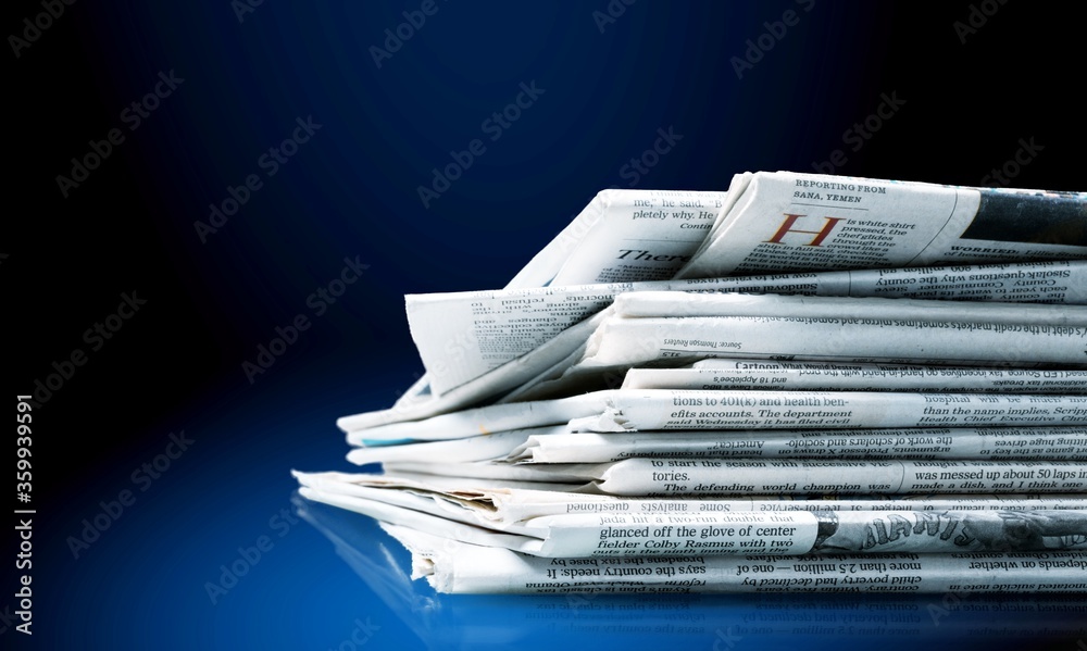 Pile of newspapers stacks on bluÐµ background