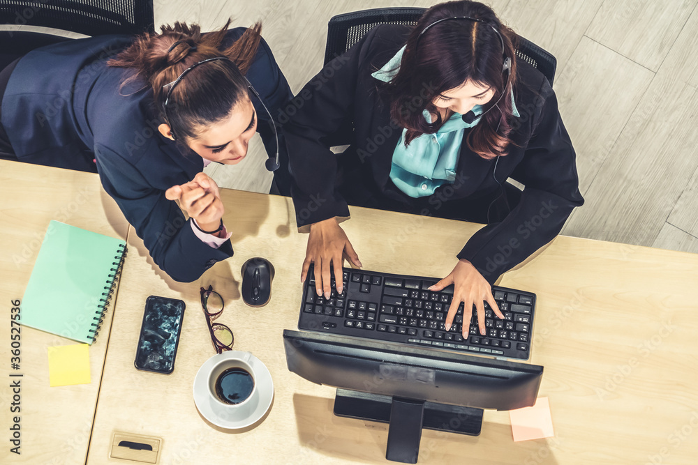 Business people wearing headset from top view in office working with computer to support remote cust