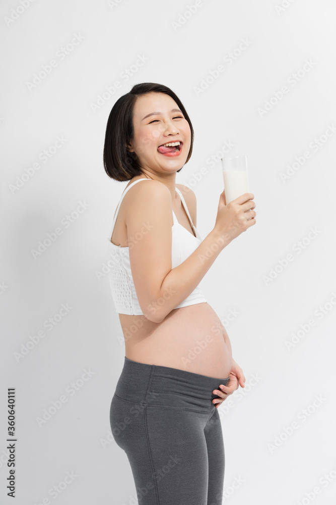 Pregnant woman holding glass of milk in her hand good healty, isolated on white background.