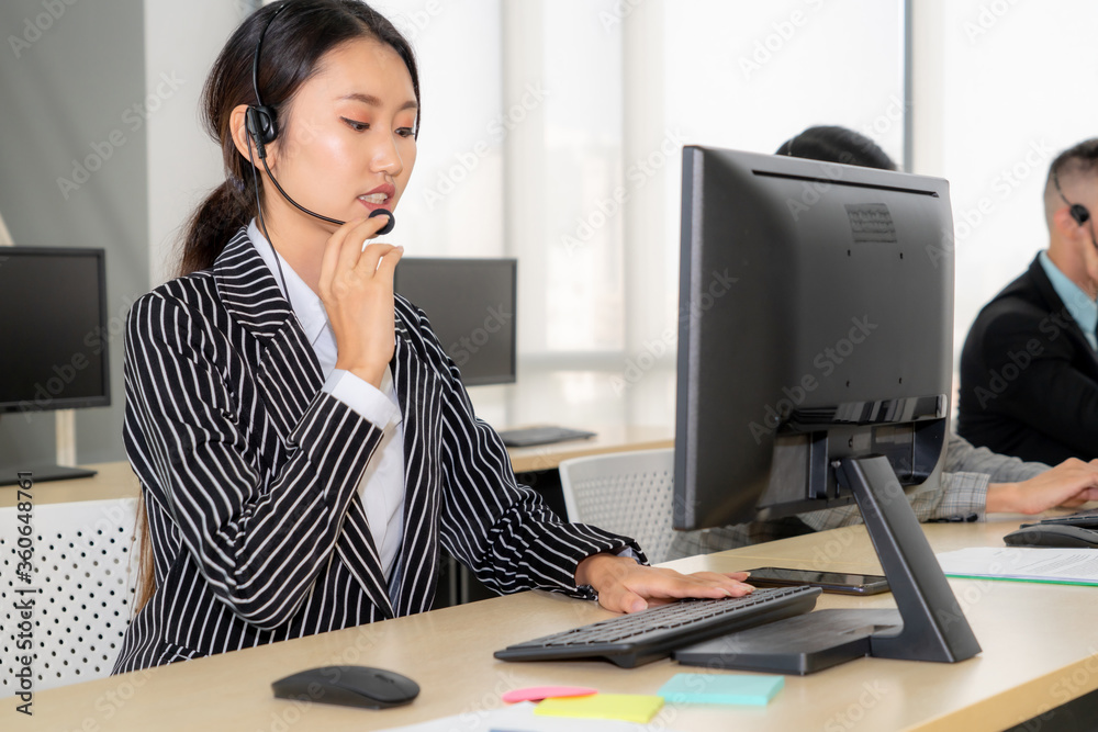 Business people wearing headset working in office to support remote customer or colleague. Call cent