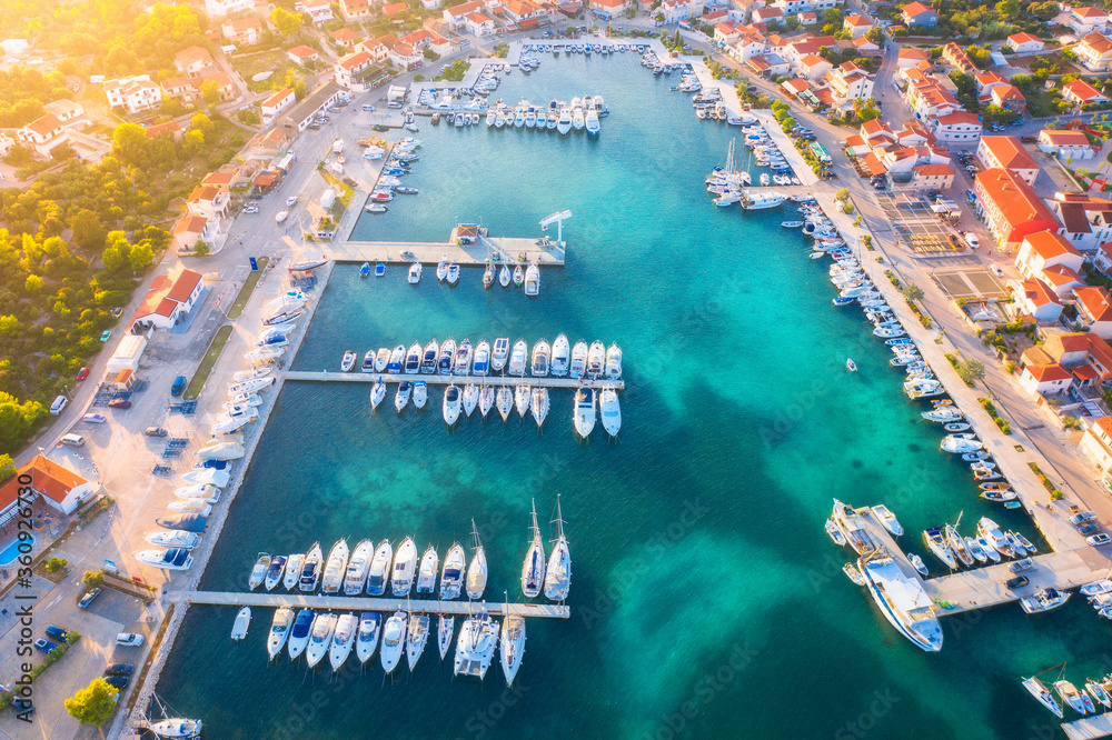 Aerial view of boats and yachts in port in beautiful old city at sunset in Croatia in summer. Landsc