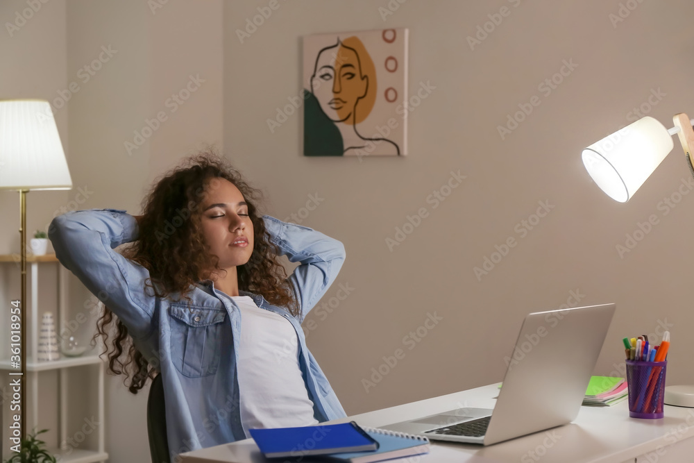 Young woman having break during online learning at home