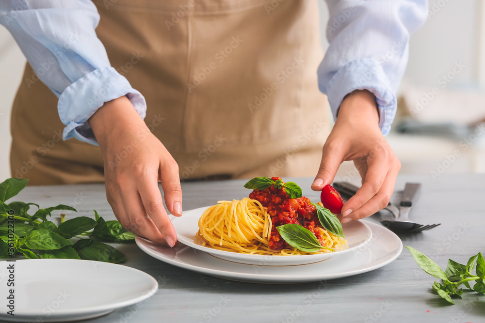 Woman cooking tasty pasta bolognese, closeup