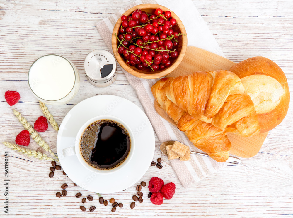 Breakfast in the morning with black coffee cup with bread with Croissant and fruit on the wooden tab