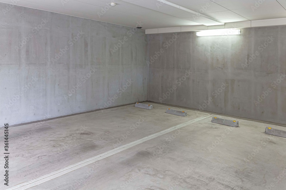 Underground car parking lot. Indoor parking area. Concrete basement floor parking garage