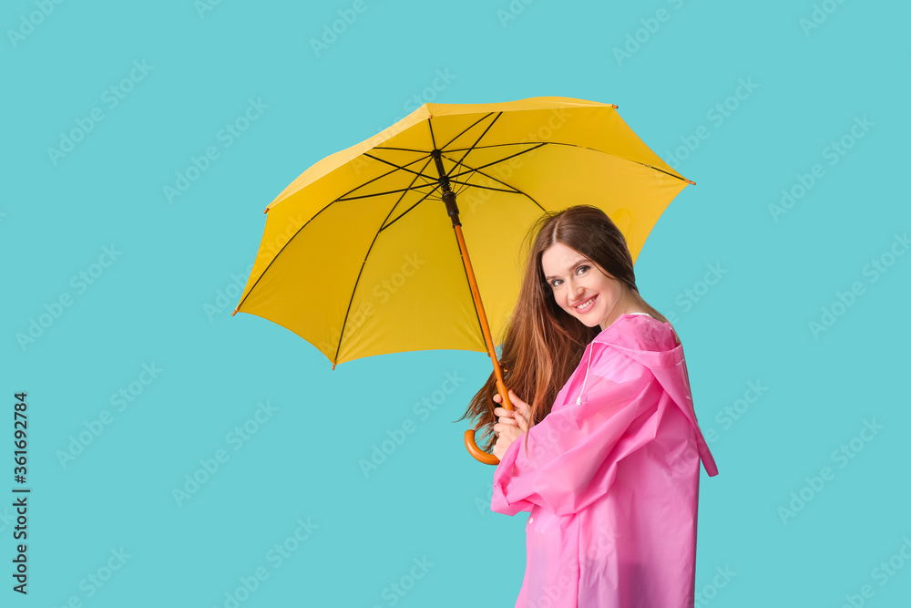 Beautiful woman with umbrella on color background