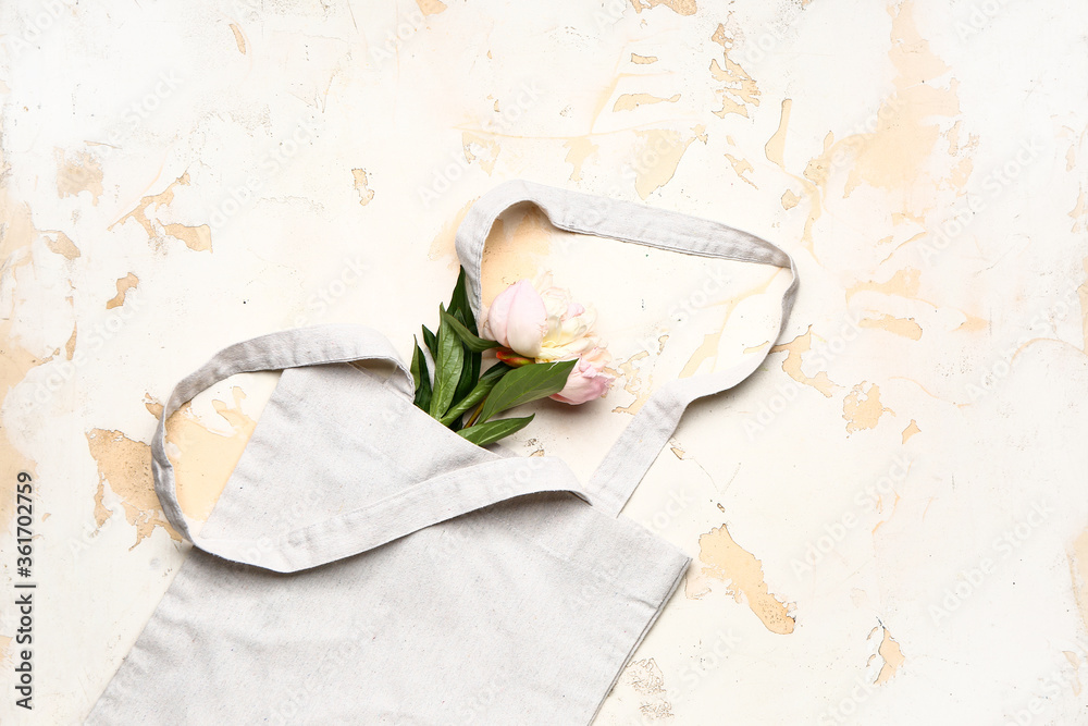 Eco bag with flowers on light background