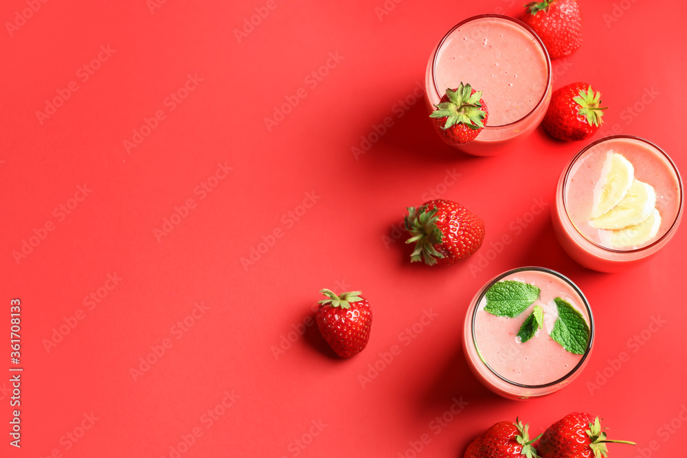 Glasses of tasty strawberry smoothie on color background