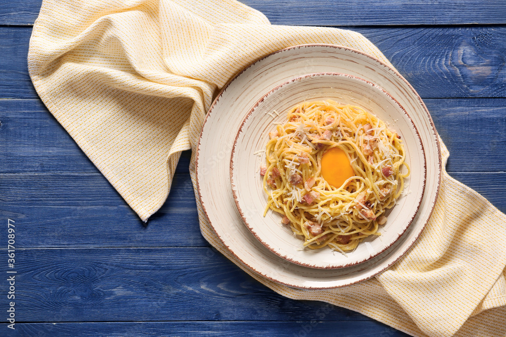 Plate with tasty pasta carbonara on table